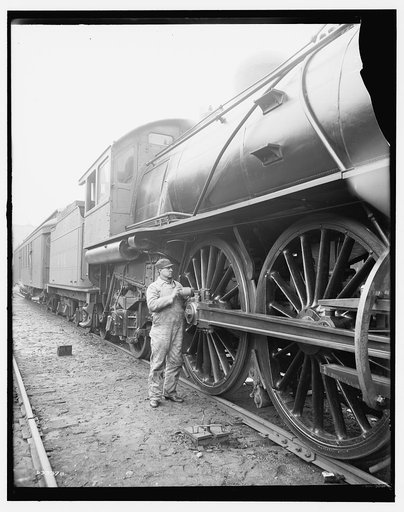 Railroad engineer oiling up before the start