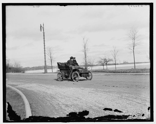 Automobile on road by waterfront