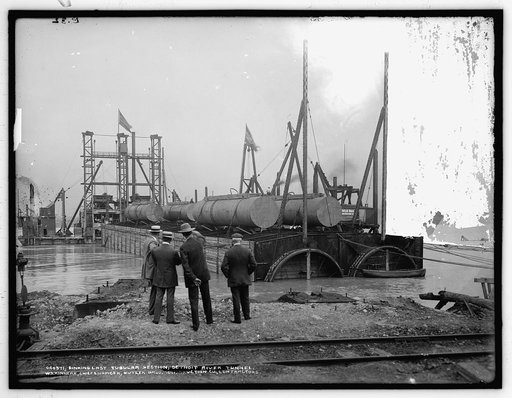 Sinking last tubular section, Detroit River tunnel, W.S. Kinnear, chief engineer, Butler Bros. Construction Co., contractors