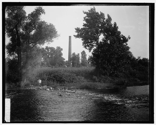 Smokestack by river, probably the Huron River, Ypsilanti, Michigan