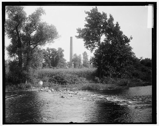 Smokestack by river, probably the Huron River, Ypsilanti, Michigan