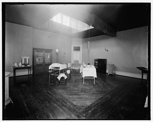 Room with medicine cabinet, basins, and massage or treatment table, probably the Ypsilanti mine bath house, Ypsilanti, Mich.