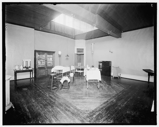 Room with medicine cabinet, basins, and massage or treatment table, probably the Ypsilanti mineral bath house, Ypsilanti, Michigan