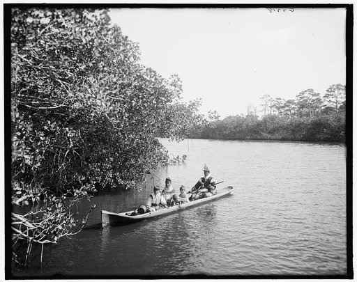 Seminole Indian and family, in dug-out canoe, Miami, Fla.