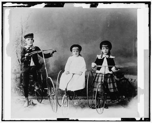 Children posed with bicycle and tricycles