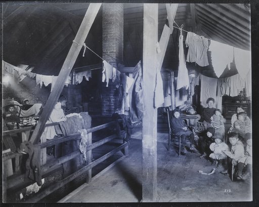 Family in an attic home with drying laundry