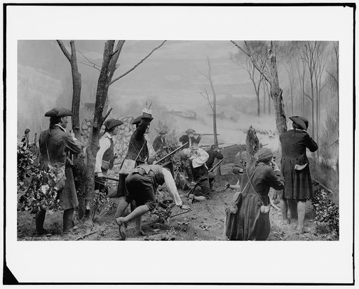 Colonial soldiers engaged in battle in a forest, possibly during the American Revolution