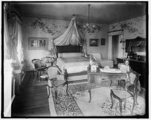 Bedroom with draped bed and writing desk