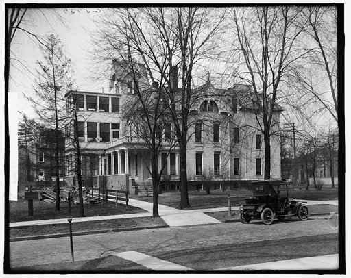 Three-story house with side porch, possibly Detroit, Michigan