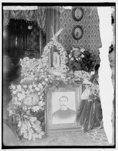 Memorial corner with wreaths surrounding portrait of man