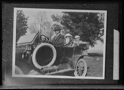 Man driving two women in automobile