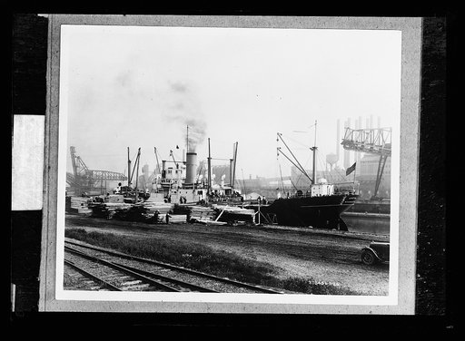 Freighter at pier with lumber, probably Mich.
