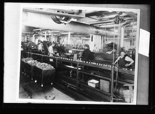 Factory workers on assembly line for bearings