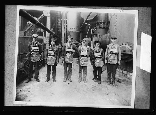 Men wearing gas masks standing in industrial building