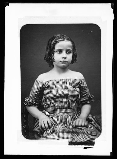 Girl with hair in ringlets and off-the-shoulder dress