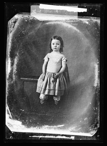 Girl in pantaloons standing by bench