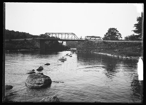 Bridge and trolley car line by water, probably Lake Winnipesaukee, N.H.