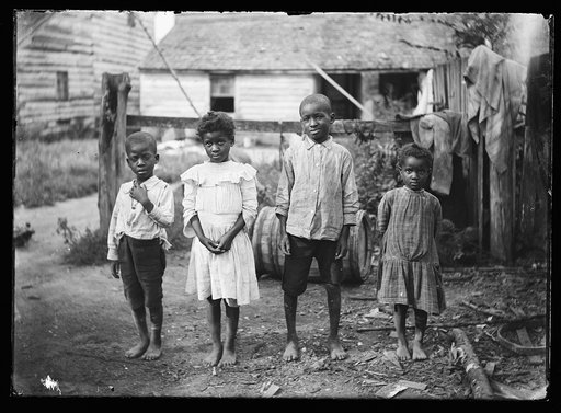 Four black children in yard