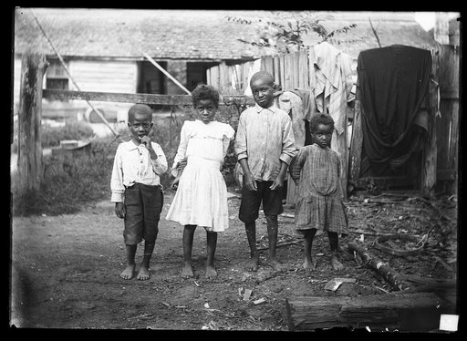 Four black children in yard