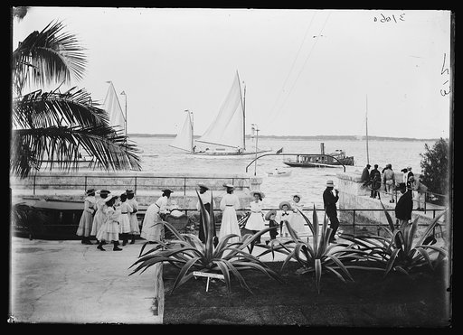 Girls watching boats at the wharf, possibly Nassau, probably Bahamas