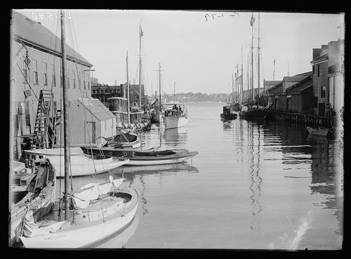 Boats at anchor, buildings and piers, possibly Portland, Maine