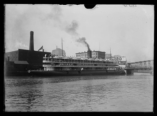 Steamer Christopher Columbus from Duluth passing industrial buildings