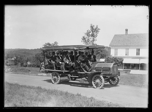 Tour bus on road, probably in Adirondack mountains