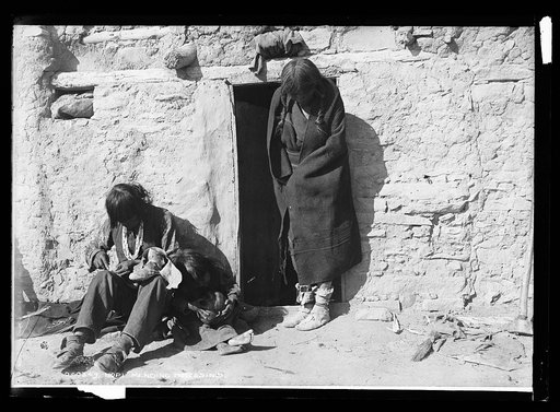 Hopi mending moccasins