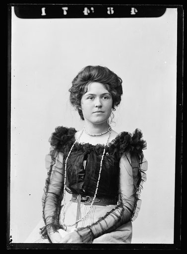 Louise Jackson in blouse with transparent sleeves, half-length portrait