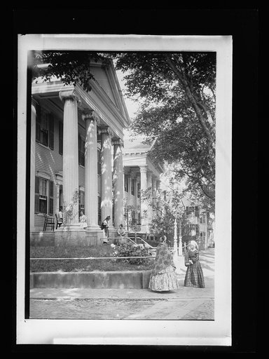 Mansion portico with costumed ladies, possibly a museum
