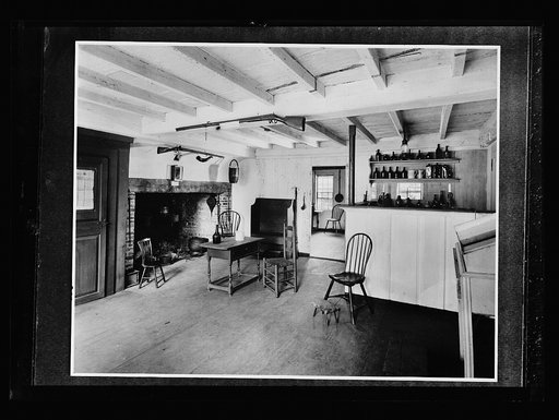 Interior, colonial-style kitchen with firearms