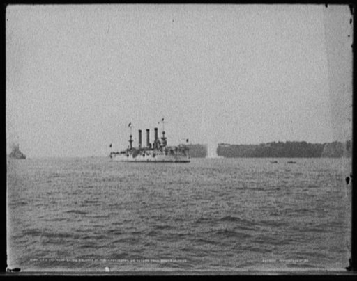 U.S.S. Brooklyn being saluted by Fort Washington on return from Santiago, 1898