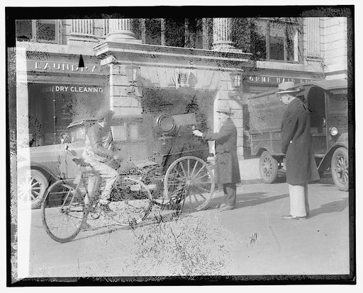 Street scene: bike, cart near laundry