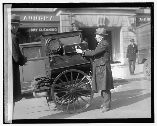 Street scene: man and cart near laundry