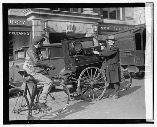 Street scene: bike, man with cart near laundry