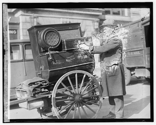 Street scene: man with cart near laundry