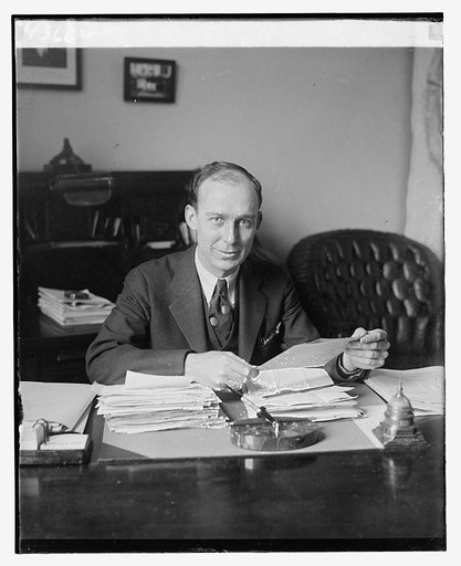 Representative Dewey J. Short of Missouri, seated at a desk