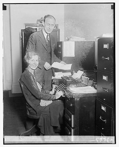 Representative Dewey J. Short of Missouri with his secretary Harriet Hosmer, at a desk with typewriter
