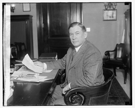 Senator Alben W. Barkley, seated at desk