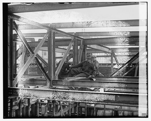 Unidentified workmen on steel beams