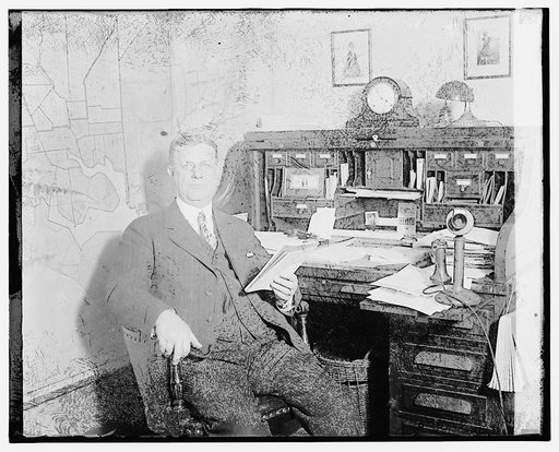Unidentified man seated at desk