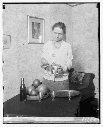 Unidentified woman juicing grapefruit