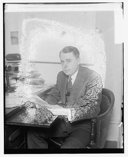 Unidentified man seated at desk