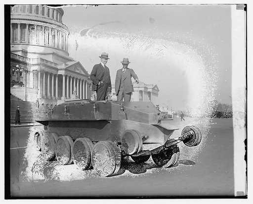 Two persons standing on tank outside Capitol building