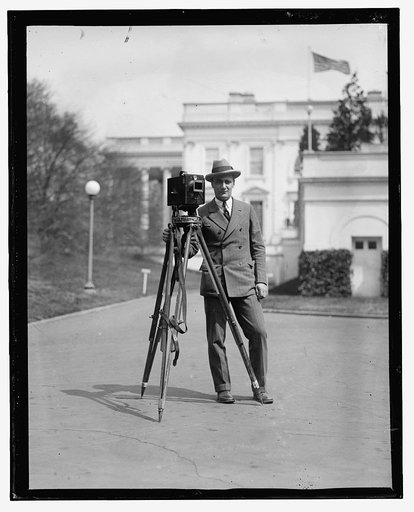 Photographer with camera outside White House