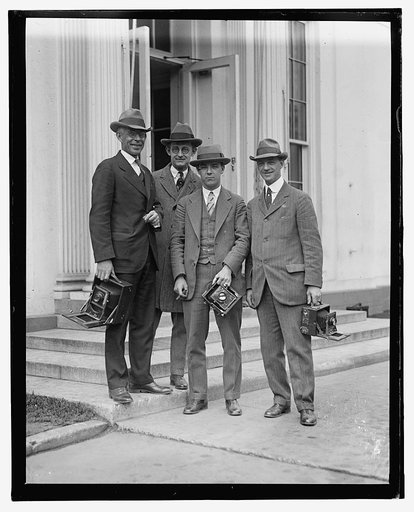 Photographers with cameras on steps