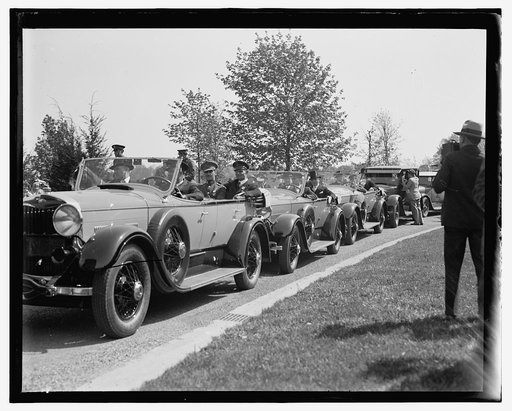 Man photographing line of cars