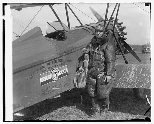 Aviator standing with plane "Cleveland Pittsburgh Air Mail ..."