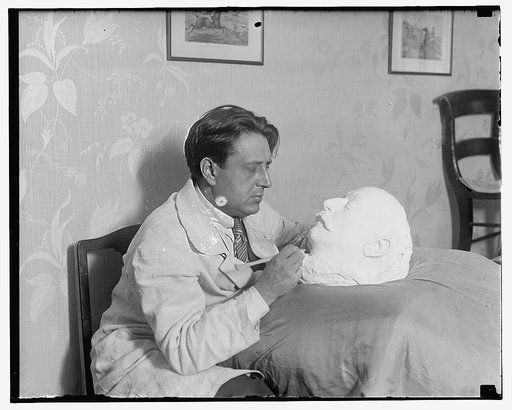 Man sculpting plaster head