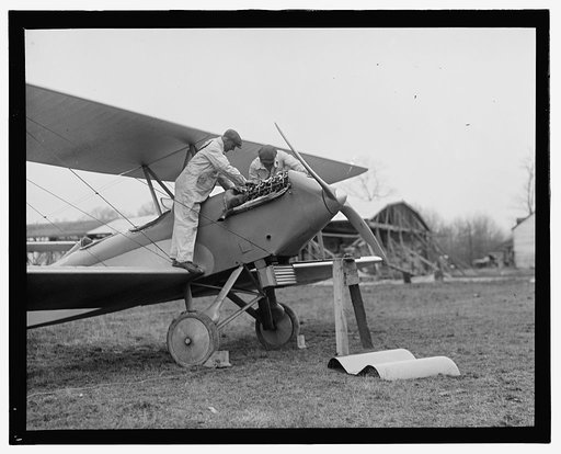 Men examining airplane engine